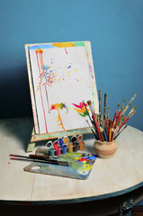 artist's palette with paints and brushes