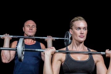 Fototapeta na wymiar Strong man and woman lifting crossfit
