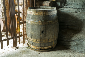 Old and dilapidated barrel in the basement