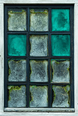 The old dilapidated window of a house