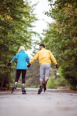 Fototapeta premium Happy couple roller blading together