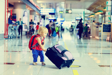 little girl with suitcase travel in the airport