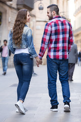 Couple walking through  European city