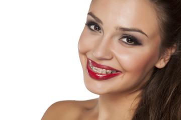 Obraz premium smiling beautiful young woman with braces
