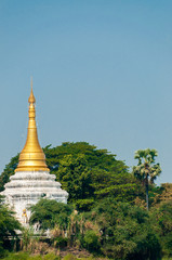 Fototapeta premium Gold white Pagoda Stupa at Irrawaddy river between trees