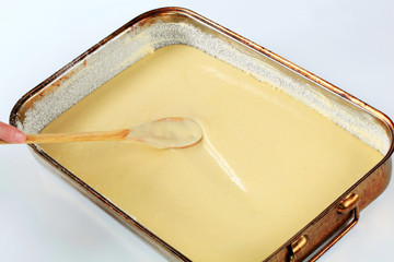 pouring batter into baking pan