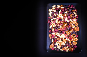 Dried fruits - pecan, cranberry, raisin, almond in black