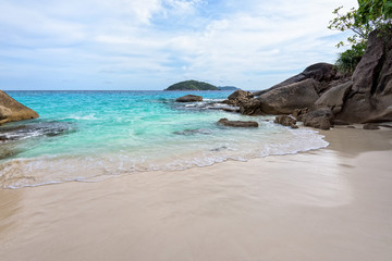 Beautiful landscape of blue sea sand and white waves on small beach near the rocks during summer at Koh Miang island in Mu Ko Similan National Park, Phang Nga province, Thailand