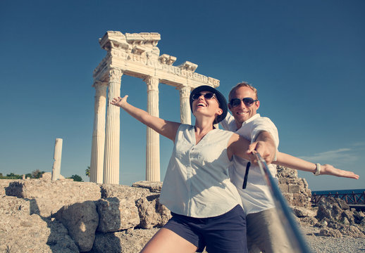 Happy young couple take a selfie photo on antique ruins