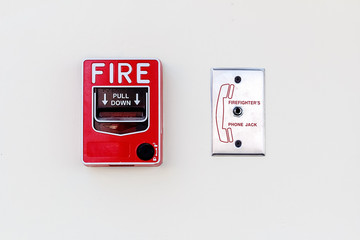 Fire Alarm and Firefighter's Phone Socket on white Concrete Wall