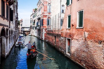 Tourists on water street with Gondola in Venice