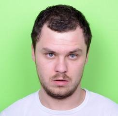 Obraz premium Portrait of man with funny face against green background