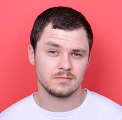 Portrait of handsome man in casual clothes against red backgroun