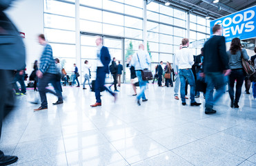 Blurred people using a skywalk/staircase
