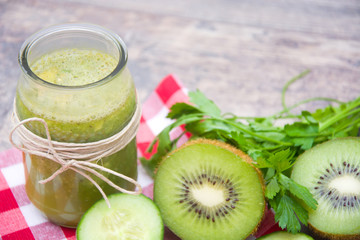 Fototapeta na wymiar Green smoothie with cucumber, kiwi and apples