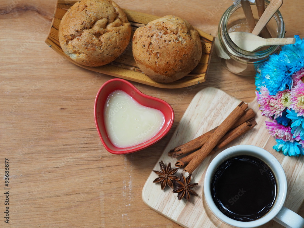 Wall mural breakfast with hot coffee and bread on wooden table