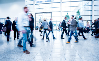 Blurred people using a skywalk/staircase
