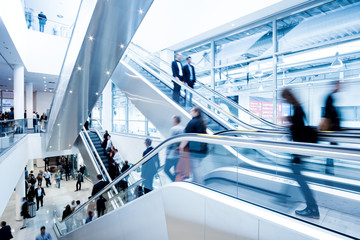 Blurred people using a skywalk/staircase