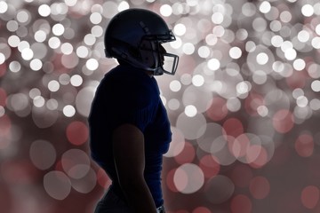 Composite image of silhouette american football player