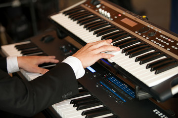 Hands playing the piano (close-up)