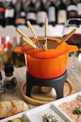 Fondue with appetizer and hot sauce with red wine