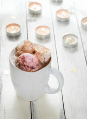 Hot chocolate with marshmallows and candle lights