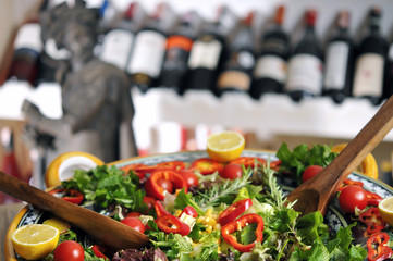 Perfect vegetarian fresh seasonal salad and wine on wooden table