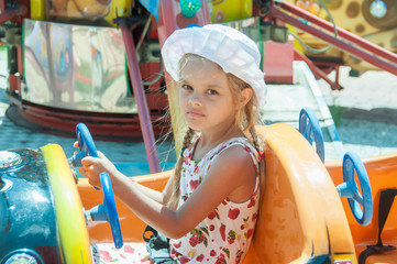 Girl rides on the carousel
