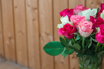 Vase with flowers standing near the window