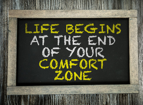 Life Begins At the End of Your Comfort Zone written on chalkboard