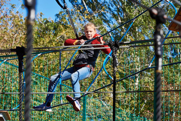 Girl is climbing to amusement park