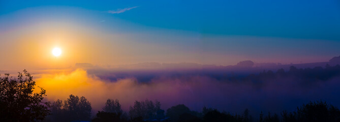 Autumn fog at misty fields, sunrise or sunset