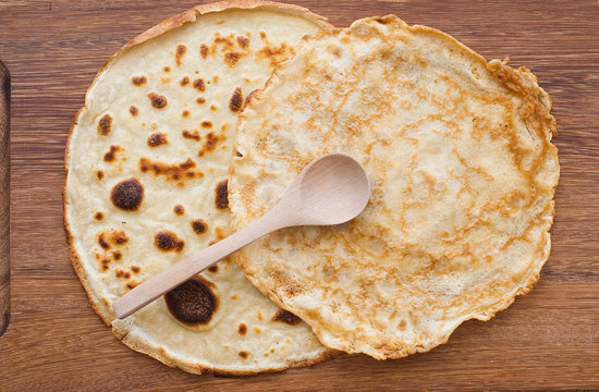 Round Pancake On Wooden Board - From Above - Studio Shot