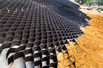 Slope erosion control with grids and earth on steep slope