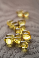 fish oil capsules on wooden tabe