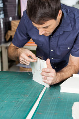 Mid Adult Worker Binding Pages At Table