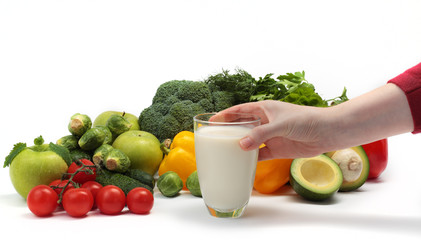 hand with glass of svirkovo cocktails on a background of vegetab