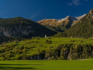 Fototapeta na wymiar Small church on top of hill in the Swiss Alps 3