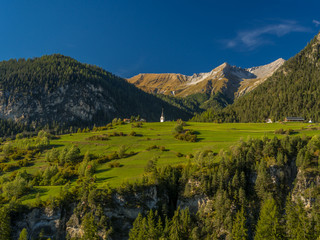 Small church on top of hill in the Swiss Alps 4