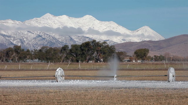 Mountain valley farm irrigation sprinkler frozen ice