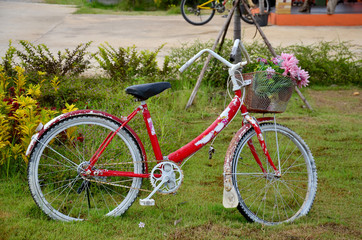 Fototapeta na wymiar Old classic red bicycle in garden