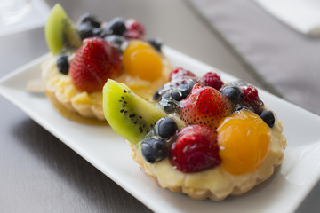 Fruit cake on a bun topped with sweet and delicious.