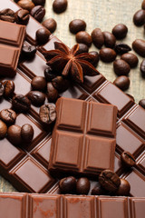 tender milk chocolate and star anise on wooden background