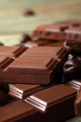 tender milk chocolate and star anise on wooden background
