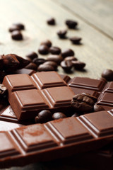 tender milk chocolate and star anise on wooden background