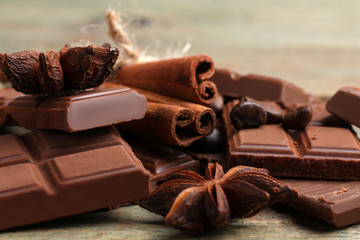 tender milk chocolate and cinnamon with anise on a wooden background