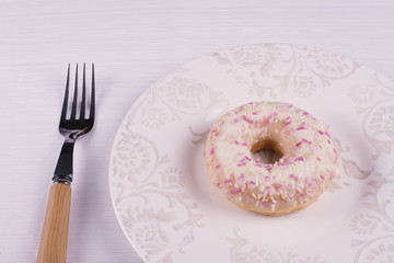 Donut on a plate with a fork