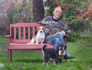 Senior man with dogs and cat