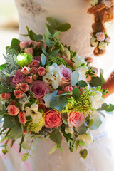 Beautiful wedding bouquet in hands of the bride