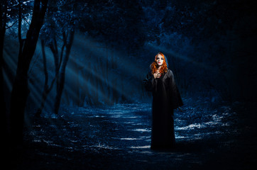 Witch in night forest
